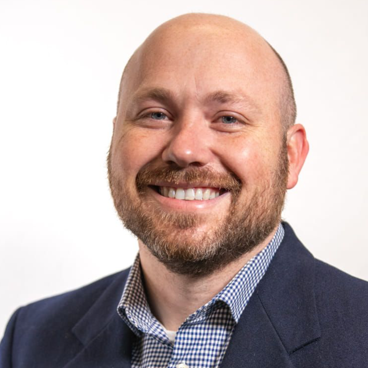 Jadrian Wooten, a white man with a beard wearing a checked shirt.